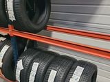 tires are stacked on a rack in a warehouse