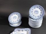 blue and white porcelain dishes and napkins on a black background