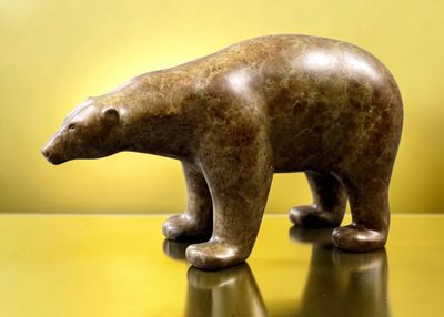 a statue of a polar bear on a shiny surface