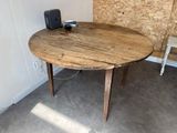 a wooden table with a camera on it in a room