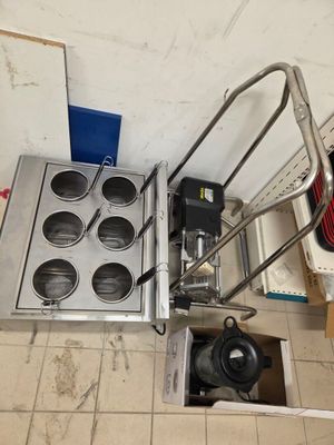 a picture of a kitchen with a stove and a hand truck