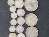 some silver coins on a black surface with a small amount of them