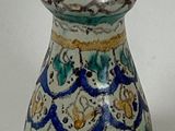 a blue and white vase sitting on a white surface