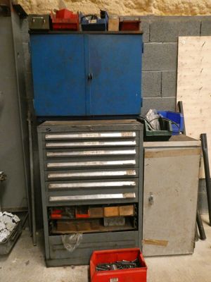a tool cabinet with tools in it in a garage