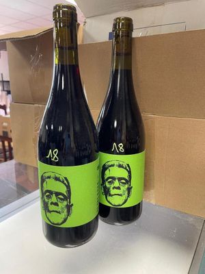 two bottles of wine that are sitting on a counter