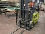 a fork lift truck in a warehouse with several pallets on it