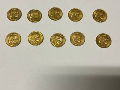 a close up of a bunch of gold coins sitting on top of a table