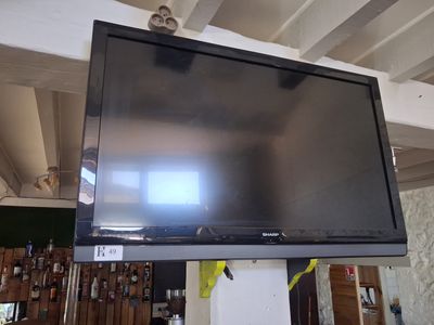a flat screen tv hanging on a wall in a room