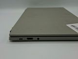 the back of a silver laptop computer sitting on top of a white table