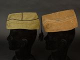 pair of black mannequin heads with hats on top of them