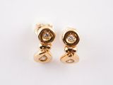 a pair of gold and diamond earrings on a white background