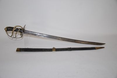 an old sword with a wooden handle sitting on top of a white surface