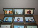 six framed pictures of different ships on a table