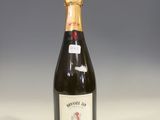 a bottle of wine sitting on top of a white table