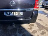 a black car that is parked on the side of the street