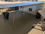 a desk with a computer and a chair in the room