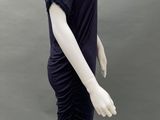 a mannequin wearing a black dress on a mannequin base