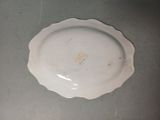 a white plate with a yellow design on it on a table