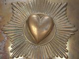 a gold helmet with a heart in the center