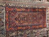 a rug hanging on a wall in a room