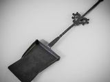 une pelle noire avec un manche en métal posée sur une surface blanche