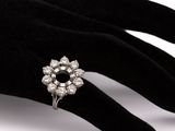 an image of a woman ' s hand with a diamond ring on it