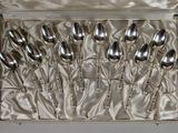 silverware in a silver case with satin lining on a table