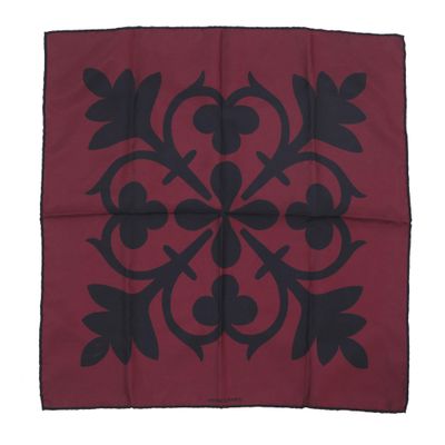 a red and black square with a black design on it