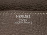 the inside of a brown leather bag with a white stitching