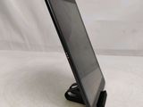 a close up of a tablet computer on a stand on a white surface