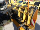 an image of a snow plow parked on the side of the road