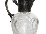 a glass pitcher with a metal handle on a white background