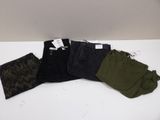 three pairs of pants sitting on top of a table next to each other