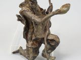 bronze figurine of a man holding a spoon and a bowl