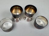 three silver cups sitting on top of a table next to each other