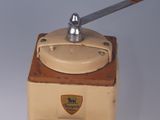 a small coffee grinder sitting on a white surface
