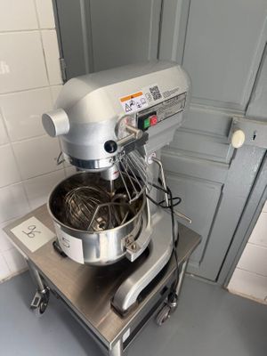 a mixer that is sitting on a stand in a kitchen