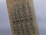a sculpture of a wooden block with a number of people on it