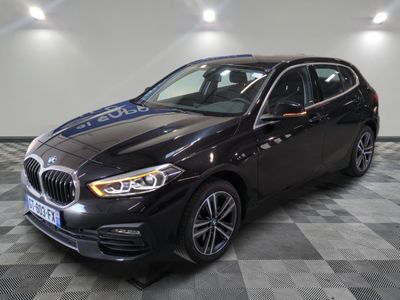 a black bmw m140i sports wagon parked on a checkered floor