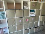 a room that has a bunch of boxes on the shelves