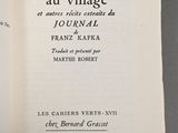 an open book with a picture of a village on it