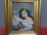 an old picture of a young girl holding a basket in her hand