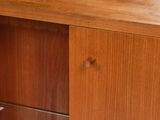 a wooden cabinet with a glass shelf on top of it