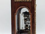 a wooden clock that is sitting on a stand