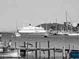 a black and white photo of a boat docked at a dock