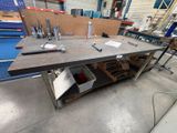 a workbench that has a lot of tools on it