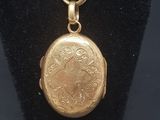 a close up of a gold locke on a black display case