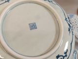a blue and white teapot with a lid on a table