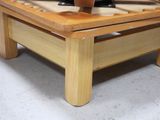 a wooden coffee table with a pair of shoes on top of it