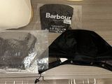a hat and a bag on a table next to a lamp